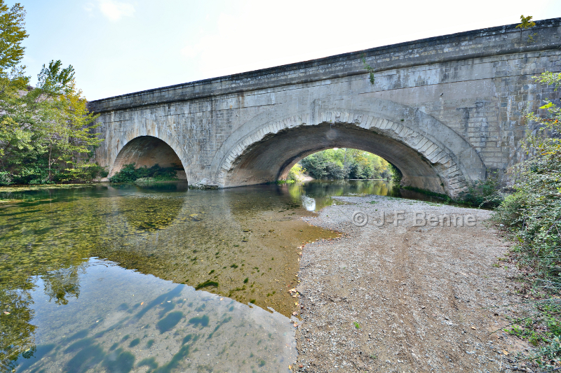 Vue de deux arches de l'aqueduc depuis les rives de la Cesse, en amont. On aperçoit très bien les dégats causés aux voussoirs de 
l'arche principale par les débris de toutes sortes charriées par la rivière en période de crue.
